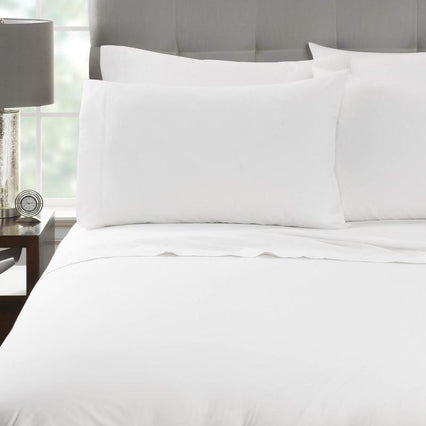 White pillowcases and pillows on a bed