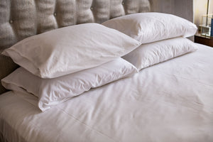Four white T180 pillowcases