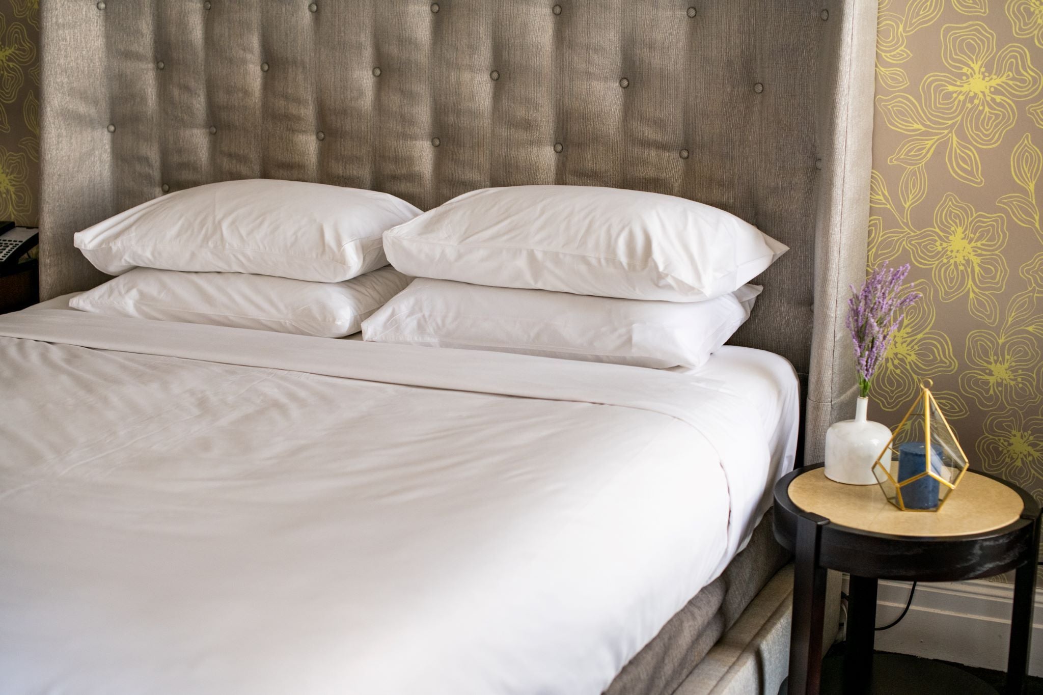 Four t200 white pillowcases on a hotel bed